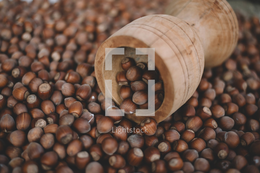 Hazelnuts in a wooden bowl on rustic background