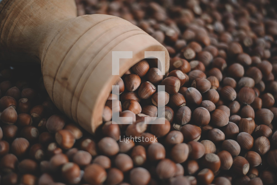 Hazelnuts in a wooden bowl on rustic background