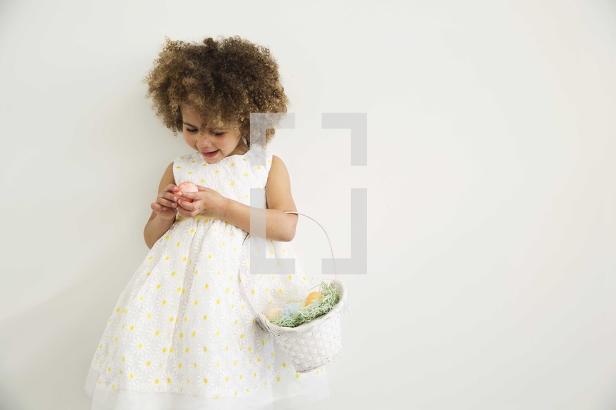 a girl child holding an Easter basket 