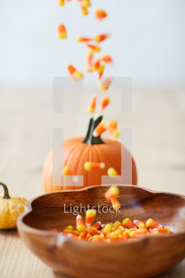 filling a bowl with candy corn 