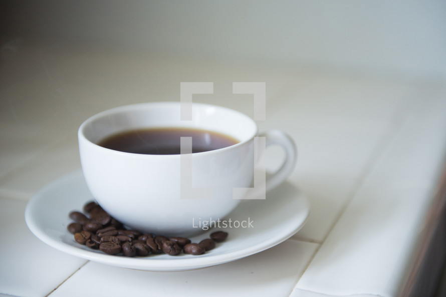 coffee cup and saucer and coffee beans 
