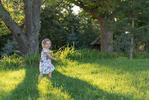 toddler girl running in grass