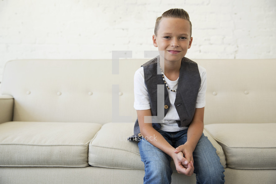 portrait of a boy child sitting on a couch