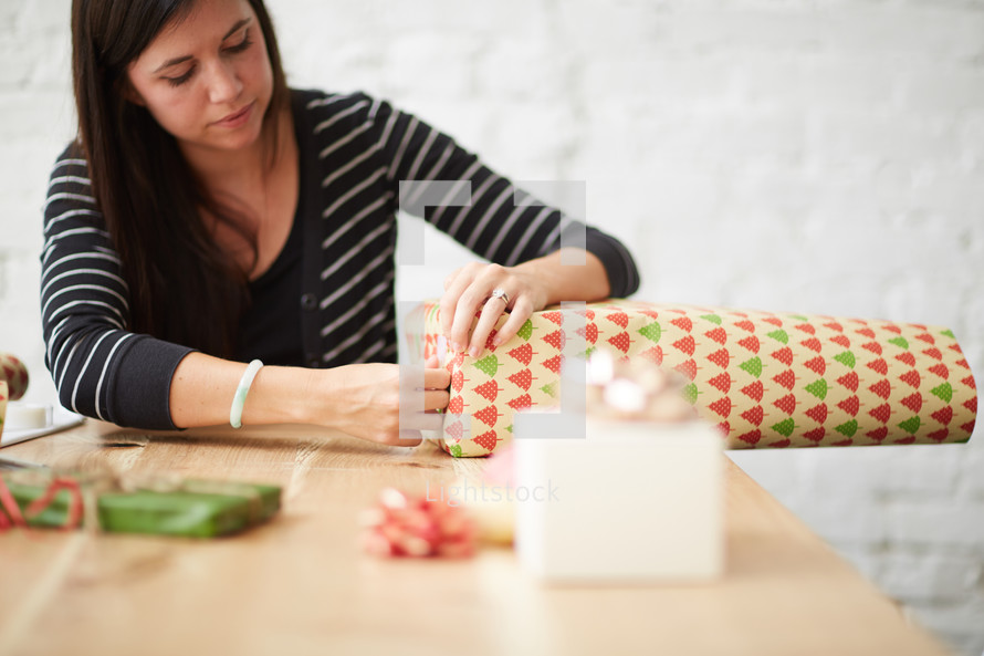 a woman wrapping Christmas presents 