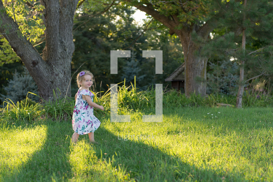 toddler girl running in grass