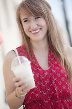 Woman holding a frozen latte.