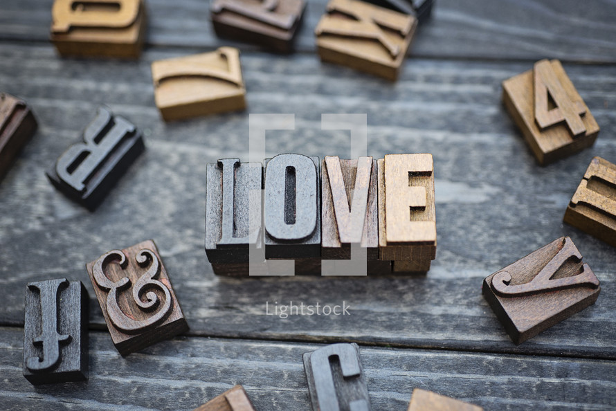 wooden print press stamps forming the word love 
