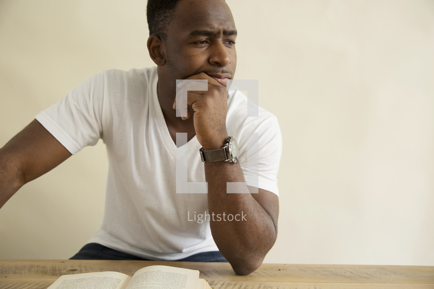 an African American man reading a Bible 