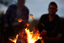 roasting marshmallows over a campfire 