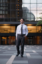 A man in a business suit in a courtyard 