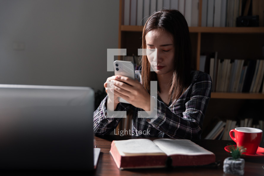 Women with Bible and technology