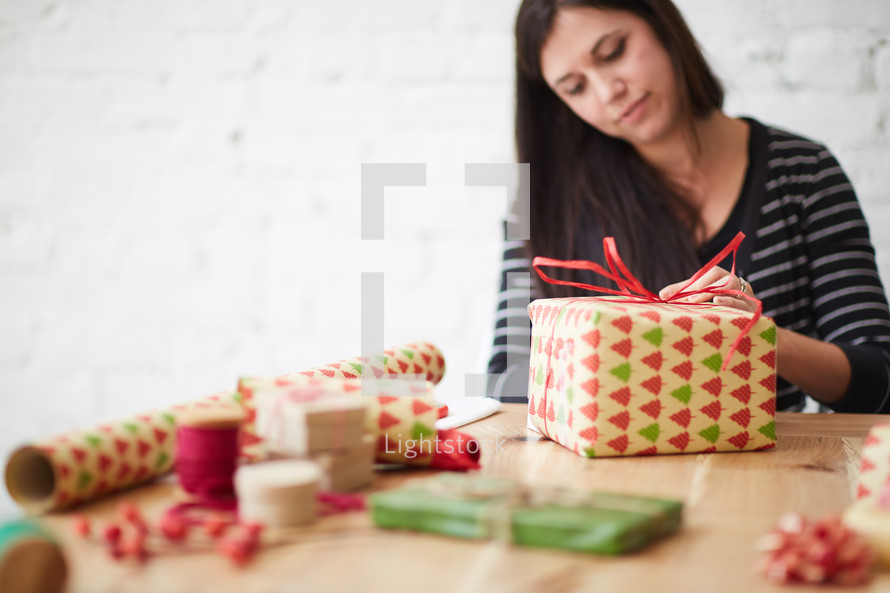 a woman wrapping Christmas presents 