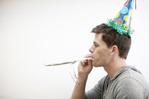 A man wearing a party hat. 