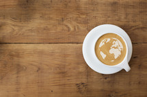 world map in the froth of a latte.