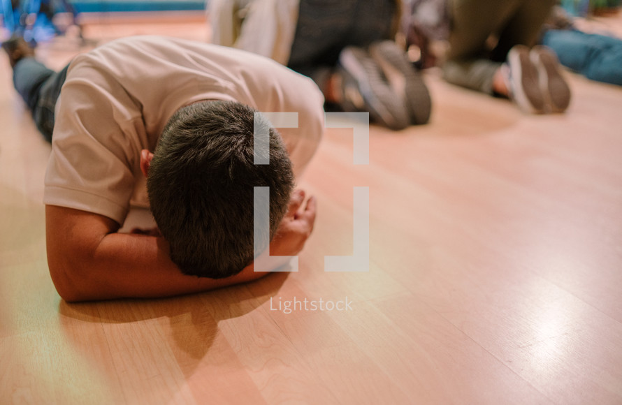 lying on the floor in tears during a worship service 
