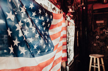 American flag hanging in a window in a bar 