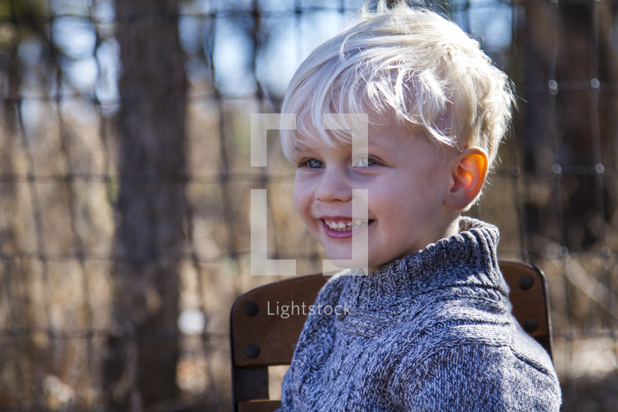 a smiling blonde boy child 