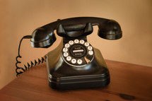 vintage telephone on a wooden desk 