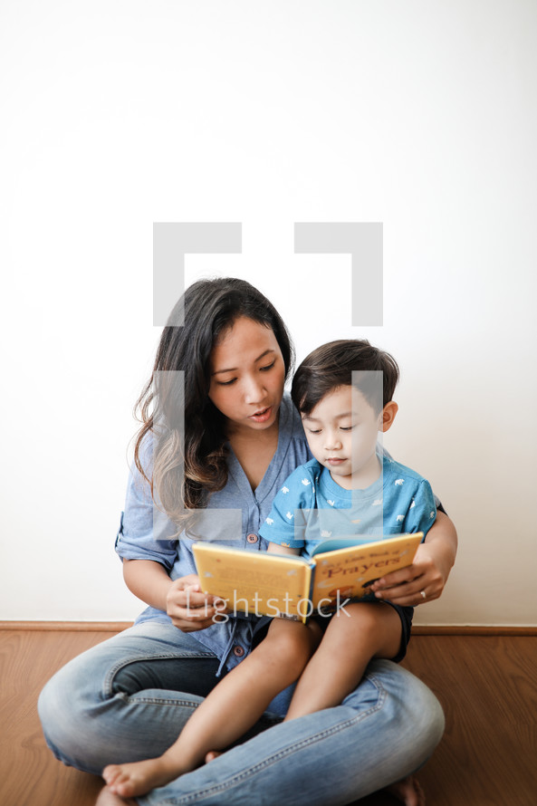 a mother reading to her son 