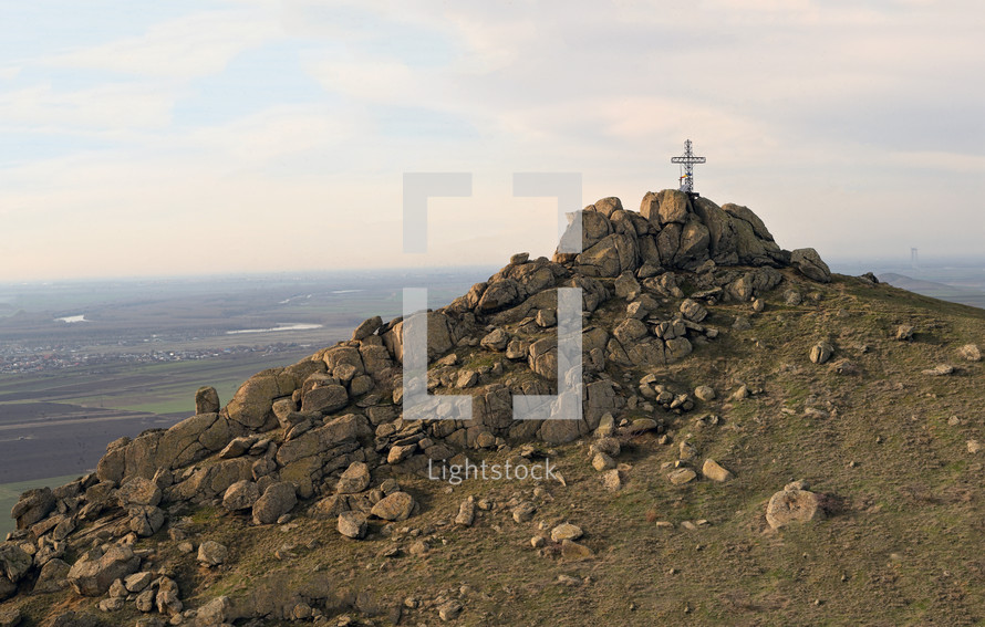 cross on a mountain peak - Cross View from Pricopan Peak in Macin Mountain