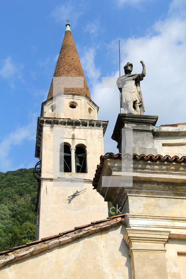 Steeple and statue on an ancient swiss church 
