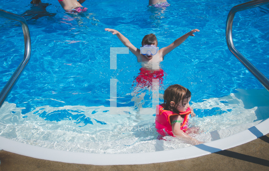 children swimming in a pool 