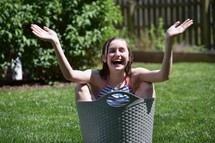 happy child in a bucket of water 