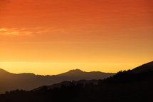 orange and yellow sky and mountains 