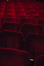 Rows of seating in a theatre or cinema, red chairs