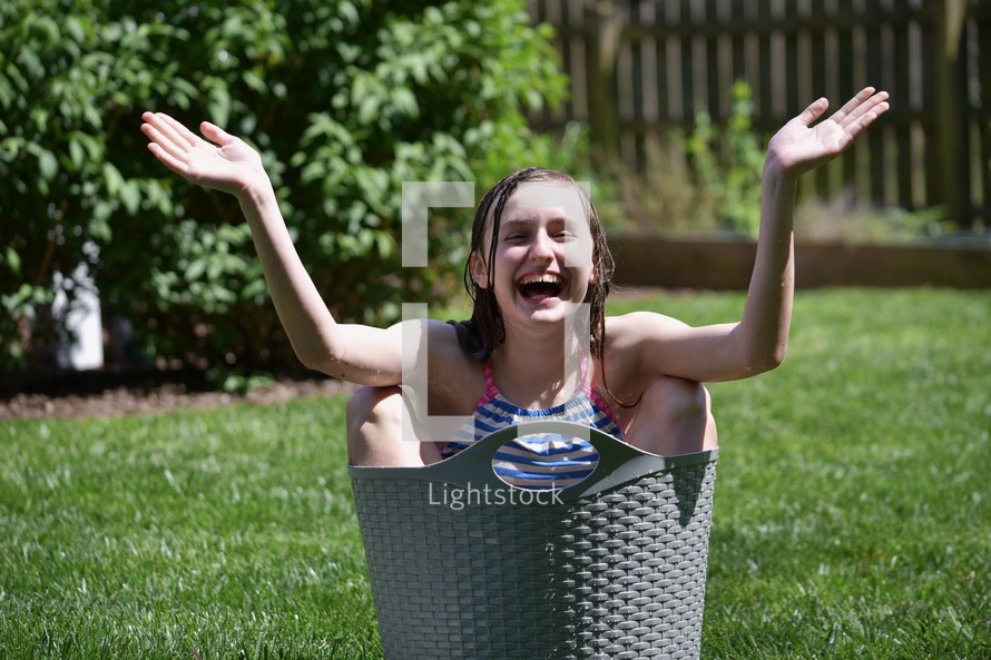 happy child in a bucket of water 