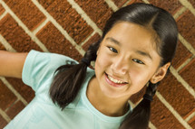 a young smiling girl with pigtails 
