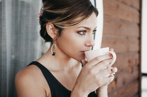 a woman drinking coffee 