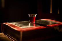 communion cup on a Bible 