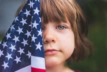 girl holding an American flag 