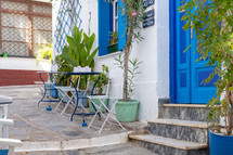 outdoor seating by a blue door 