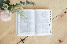 pages of an open Bible on wood table 