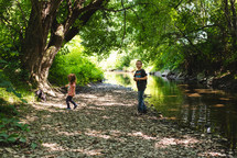 kids playing by a summer stream 