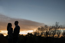 silhouette of a couple holding each other close 