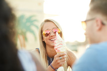 friends eating ice cream cones outdoors 