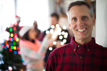 A man smiling at a Christmas party