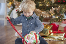 A child opening a Christmas present. 