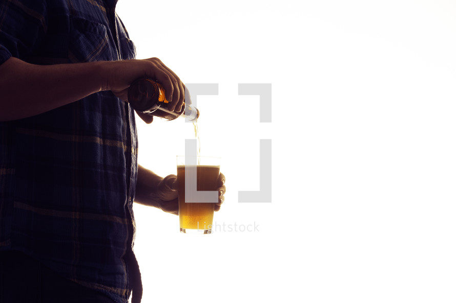 a man pouring a beer 