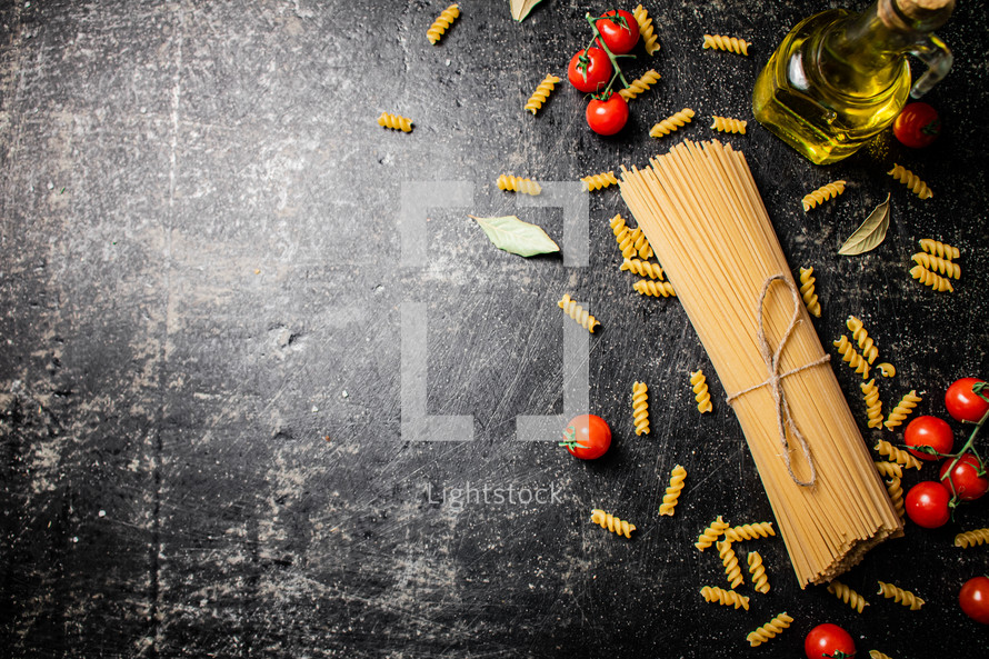 A pile of spaghetti dry on the table. Against a dark background. High quality photo