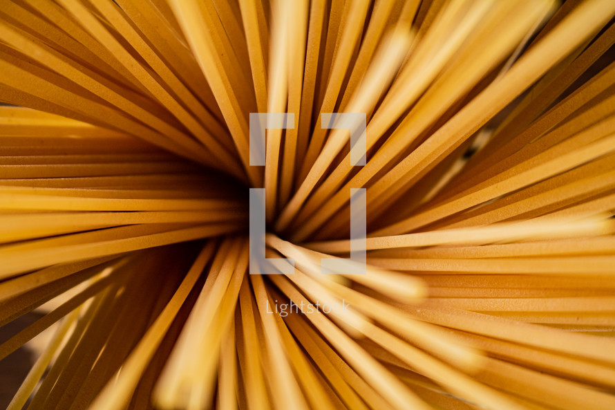 A pile of spaghetti dry on the table. Against a dark background. High quality photo