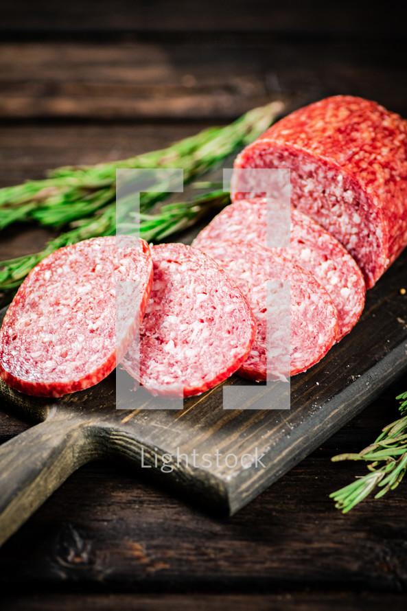 Delicious salami sausage on the table. On a black background. High quality photo