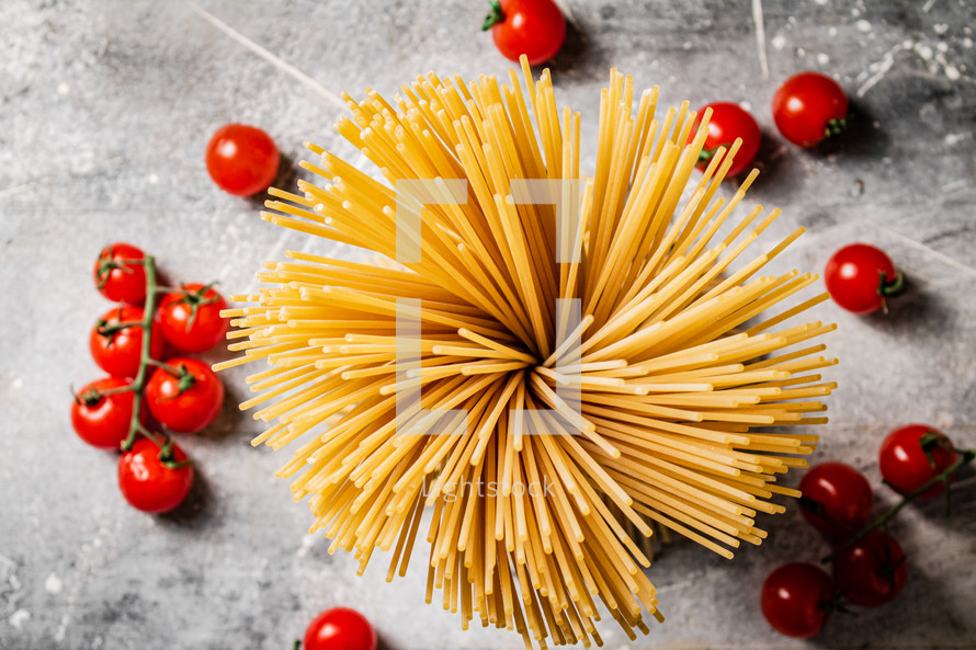 A pile of spaghetti dry on the table. Against a dark background. High quality photo