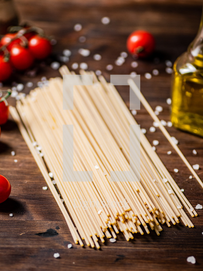 A pile of spaghetti dry on the table. Against a dark background. High quality photo