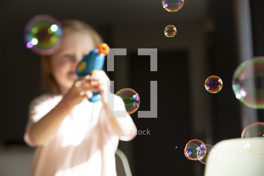 child with a bubble gun 