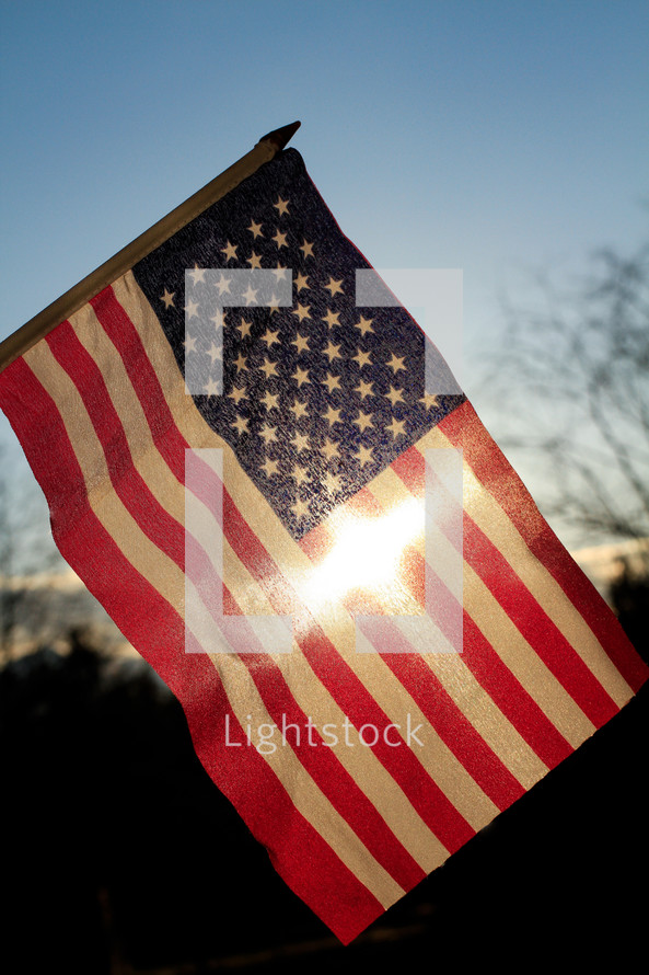 cross sunlight on an American flag 