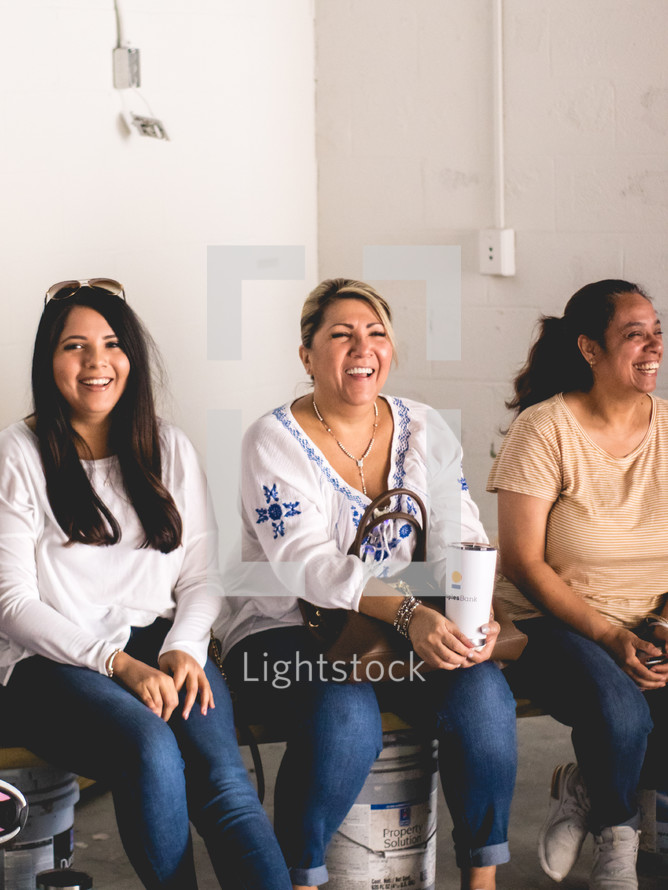 group of women sitting and smiling 